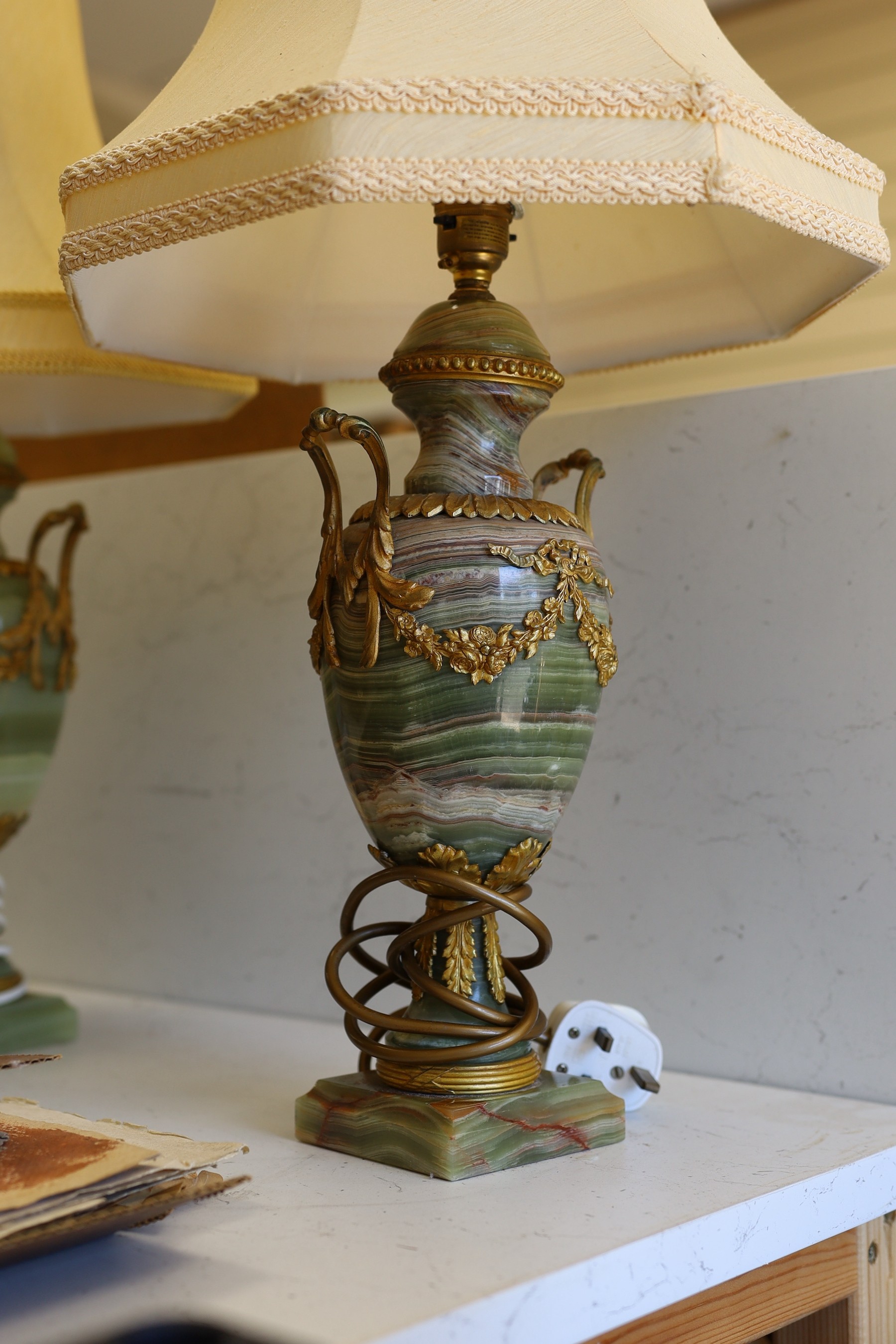 A pair of early 20th century brass mounted onyx urn shaped lamps, 35cm high not including light fitting or shade